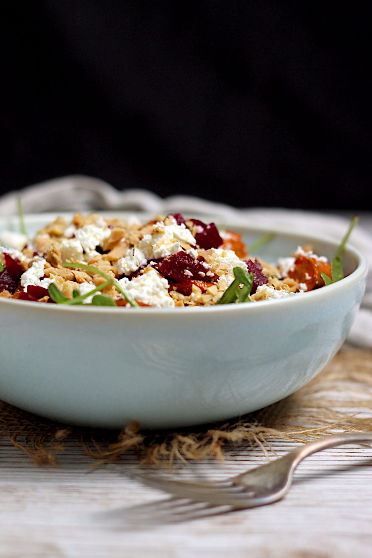 Arugula Salad with Root Vegetables and Lentils in a pale blue bowl.