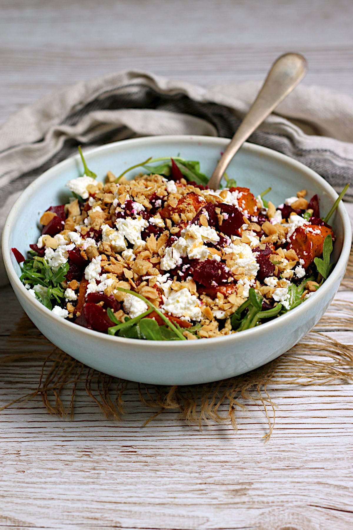 Arugula Salad with Root Vegetables and Lentils in a pale blue bowl.