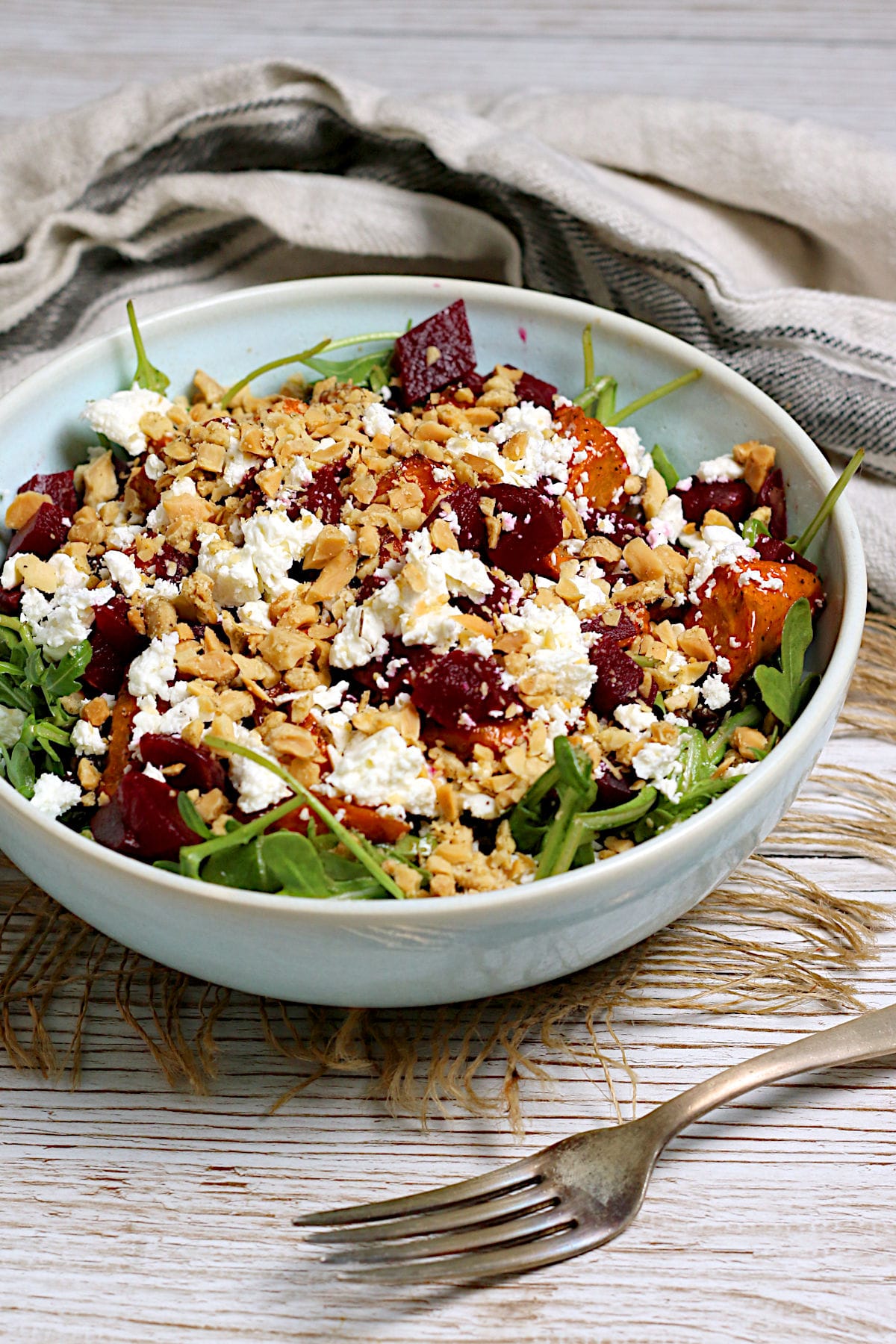 Arugula Salad with Root Vegetables and Lentils in a pale blue bowl.