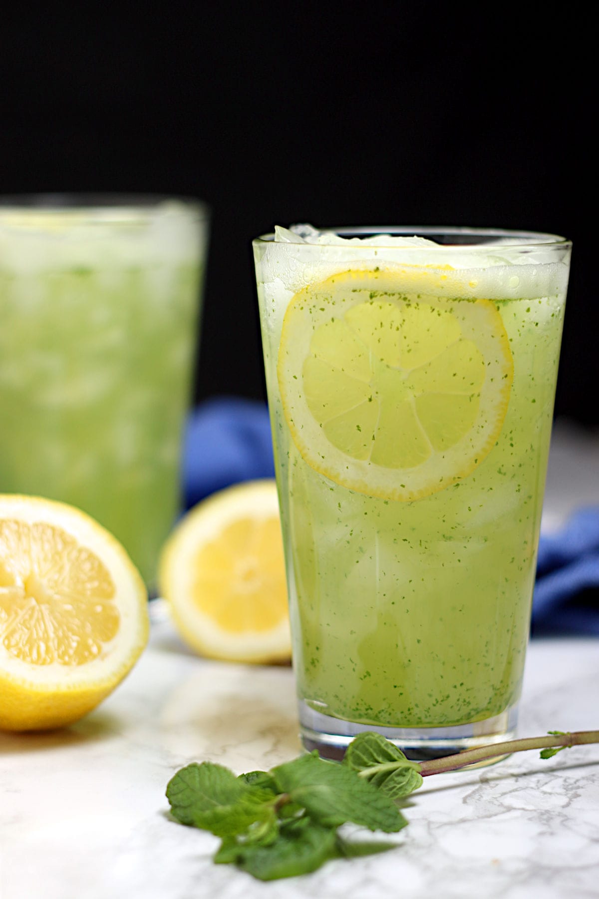 Two glasses of Middle Eastern Mint Lemonade with ice.