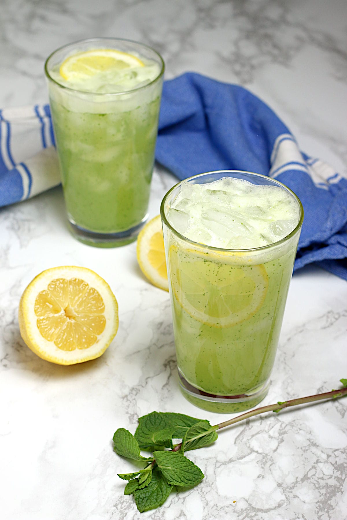 Two glasses of Middle Eastern Mint Lemonade with ice.