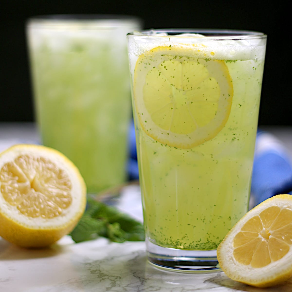 Two glasses of Middle Eastern Mint Lemonade with ice.