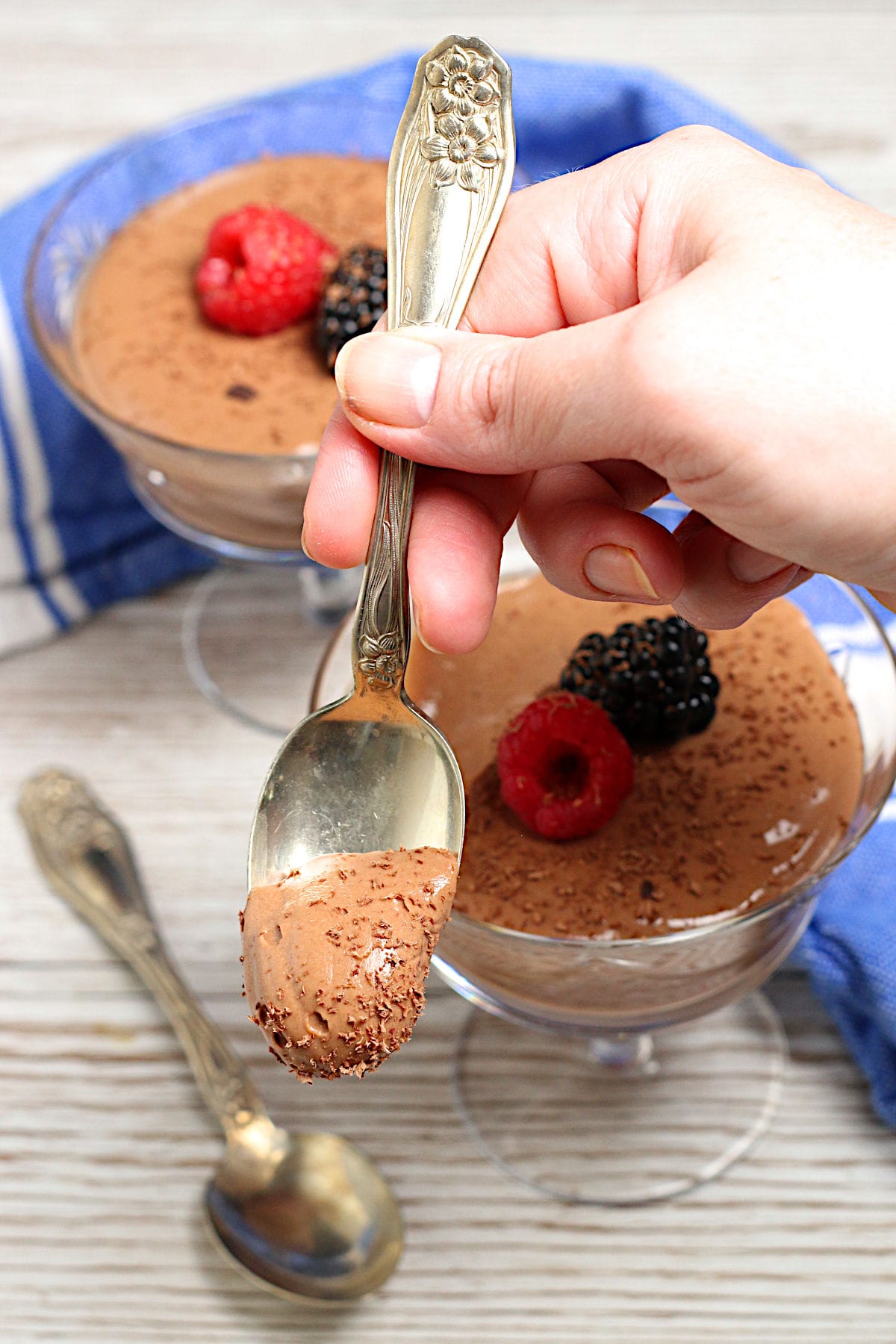Cottage Cheese Chocolate Mousse A hand holding a spoonful of Cottage Cheese Chocolate Mousse.