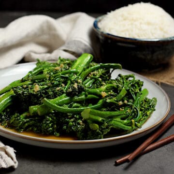 Steamed Broccolini with Garlic Sauce on a large white plate.