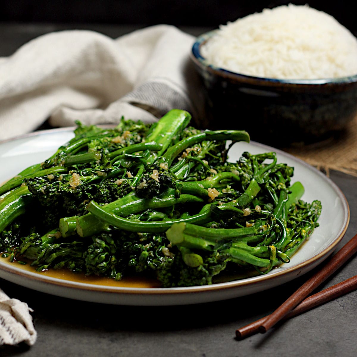 Steamed Broccolini with Garlic Sauce on a large white plate.