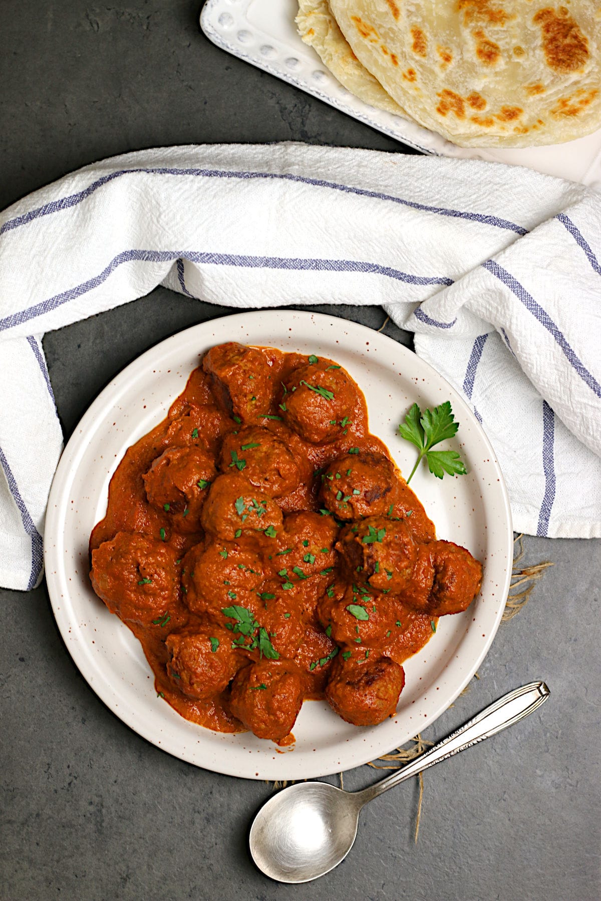 An overhead photo of Butter Chicken Meatballs on a white plate.