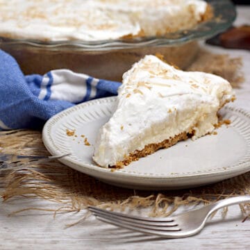 Coconut Cream Pie A slice of Coconut Cream Pie on a small white plate.
