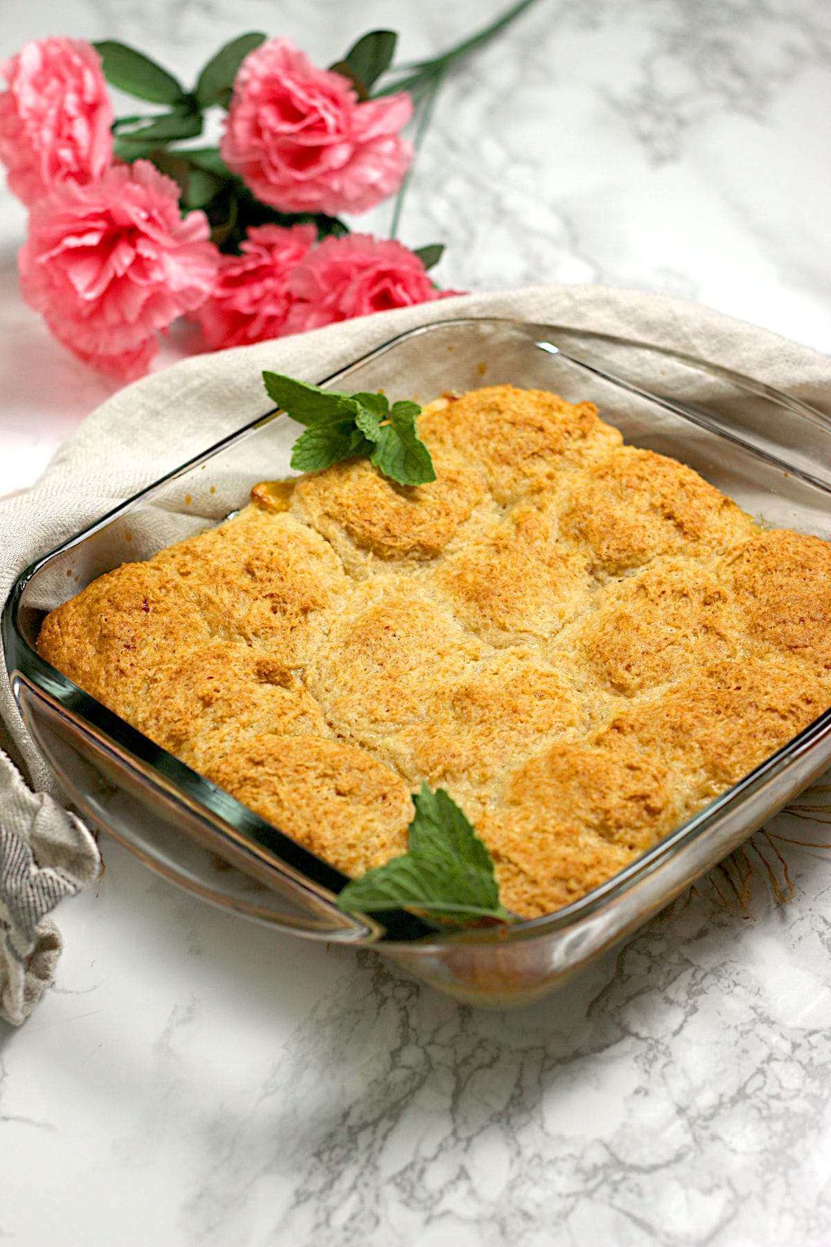 Peaches and Cream Cobbler in a glass baking dish.