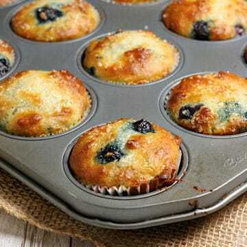 Blueberry Greek Yogurt Muffins in a muffin pan.