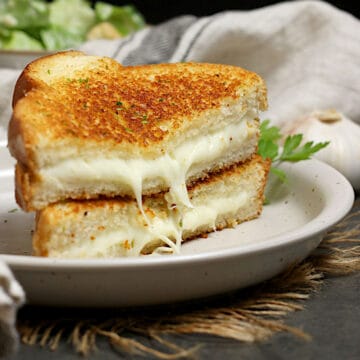 A Garlic Butter Grilled Cheese on a white plate.