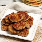 A stack of Homemade Breakfast Sausage Patties on a white plate.
