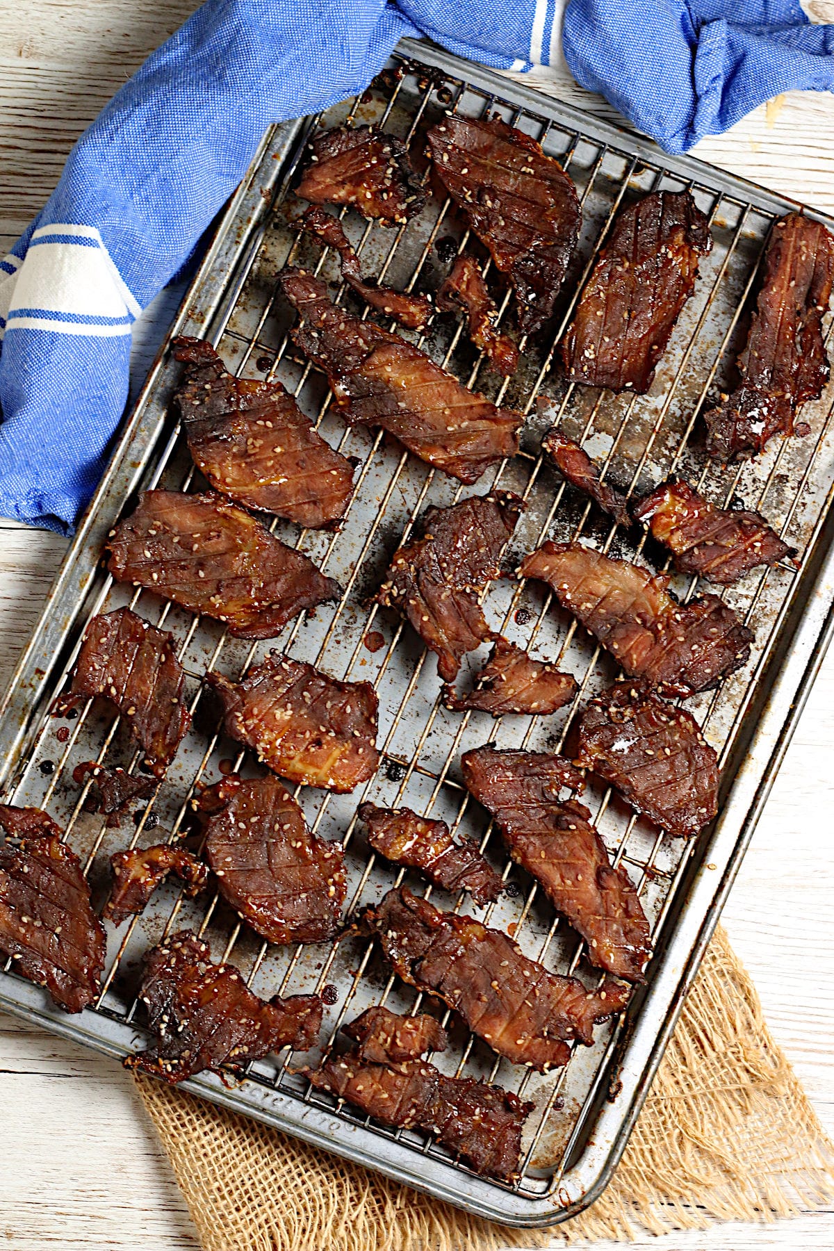 Korean BBQ Pork Jerky An overhead photo of Korean BBQ Pork Jerky on a baking sheet.