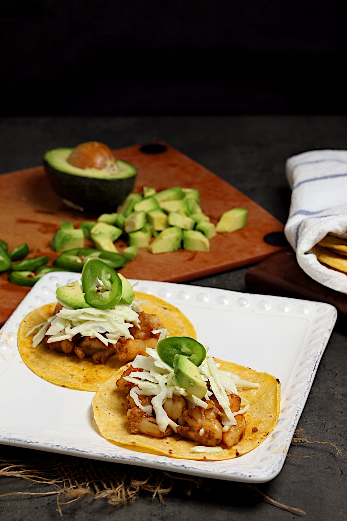 Two Shrimp Tacos with Cilantro Lime Slaw on a white plate.