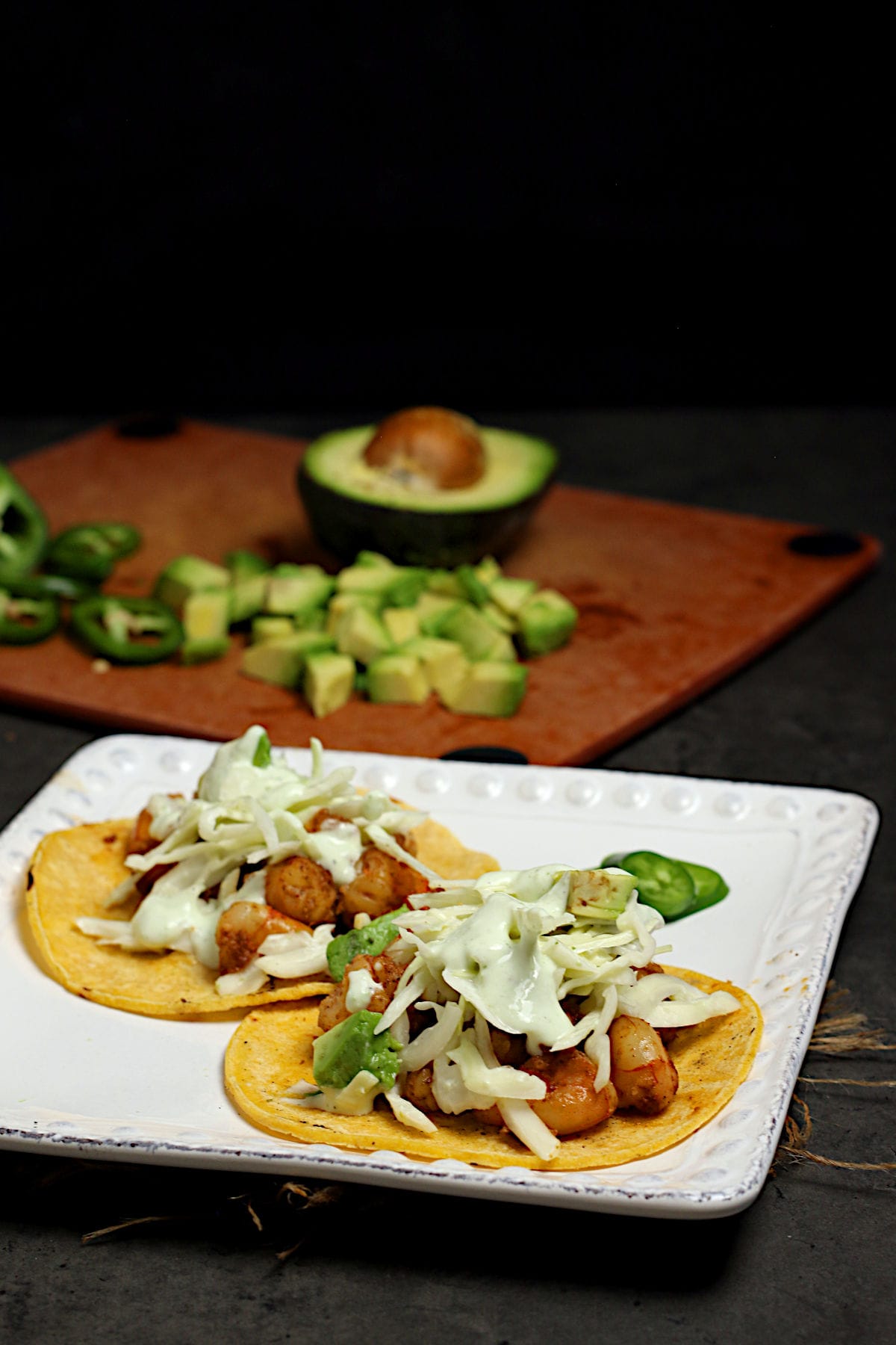 Two Shrimp Tacos with Cilantro Lime Slaw on a white plate.