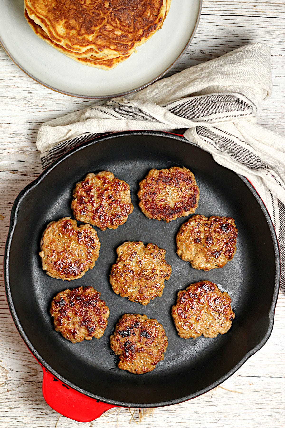 An overhead photo of homemade Breakfast Sausage Patties in a cast iron skillet.