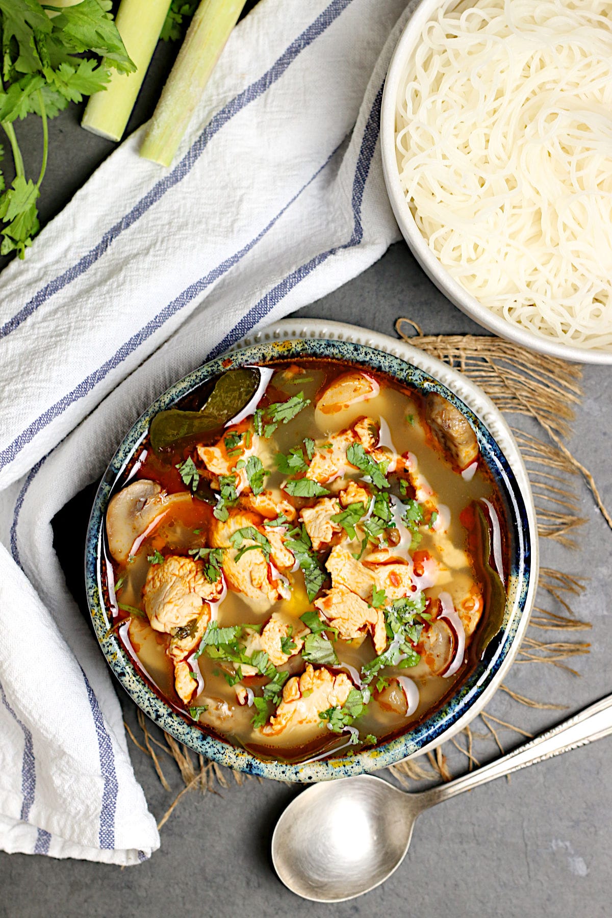 An overhead photo of A bowl of homemade Tom Yum Gai (Thai Hot and Sour Chicken Soup with Chicken).